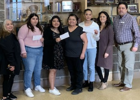 Photo of students and parents receiving scholarships 